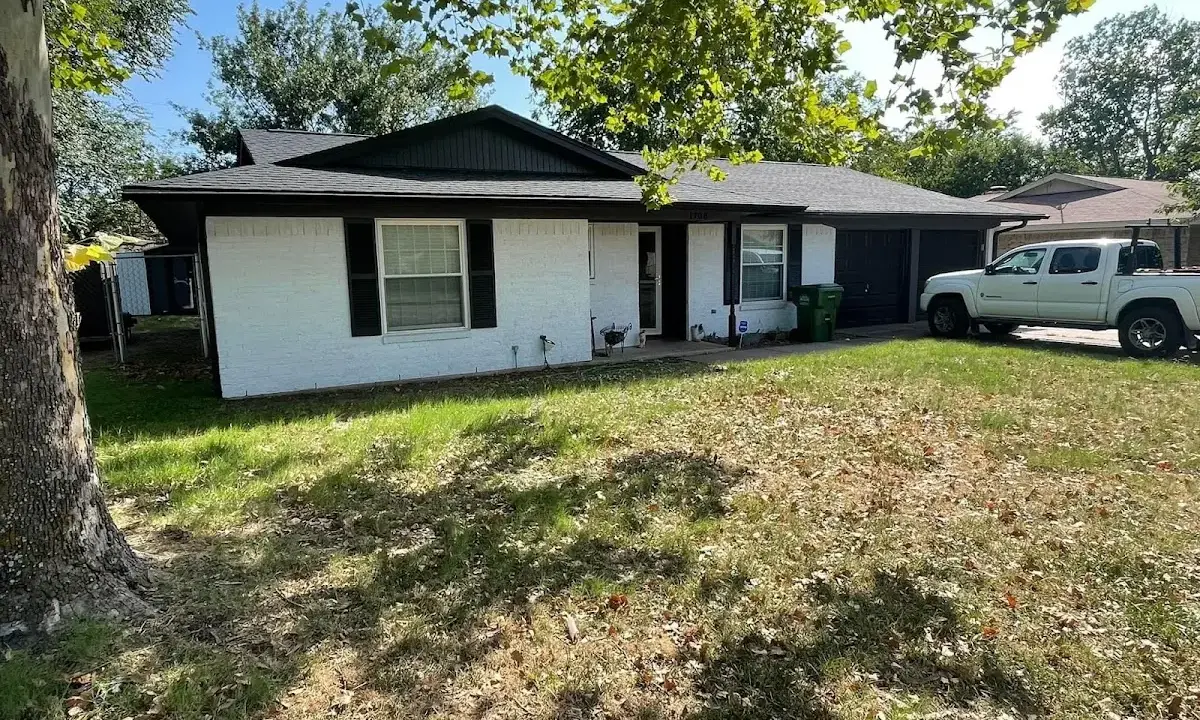 Professional roofing crew working on a residential roof in Branford